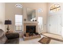 Inviting living room with vaulted ceilings, a cozy fireplace, and ample natural light at 364 Rushing Creek Ct, Henderson, NV 89014