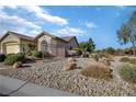 Charming single-story home with a fenced yard with mature shrubbery and desert landscaping at 3841 Budenny Dr, Las Vegas, NV 89122