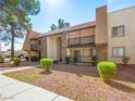Exterior view showing balconies and stone accents surrounded by manicured landscaping at 5339 Indian River Dr # 281, Las Vegas, NV 89103