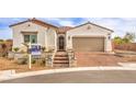 Charming single-story home featuring a well-manicured front yard, brick-paved driveway, and a two-car garage at 5755 E La Campana Dr, Pahrump, NV 89061