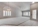 Bright living room featuring neutral paint, a large window, carpeted floor, and modern lighting at 6032 Port Of Dreams Dr, Las Vegas, NV 89130