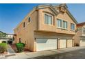 Beige two-story home with a three-car garage and well-kept landscaping at 6404 Extreme Shear Ave # 103, Henderson, NV 89011