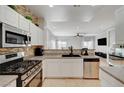 Modern kitchen features stainless appliances and white cabinetry at 6404 Extreme Shear Ave # 103, Henderson, NV 89011