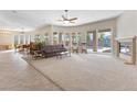 Expansive living room with fireplace, large windows, neutral tones and seamless transition to outdoor space at 6895 Kelp Ledge Ct, Las Vegas, NV 89131
