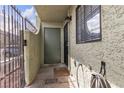 Exterior entrance featuring a security gate and door with an exterior light fixture at 7030 Burcot Ave # D106, Las Vegas, NV 89156