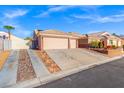 Charming single-story home featuring a three car garage, desert landscaping, and a well-maintained exterior at 7033 Red Tide Dr, Las Vegas, NV 89131