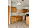 Kitchen with tile flooring, oak cabinets, and white appliances at 7977 Blue Brook Dr, Las Vegas, NV 89147