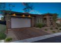 Charming single-Gathering home with a two-car garage, stone accents, and well-maintained landscaping at 8 Reflection Cove Dr, Henderson, NV 89011