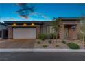 Charming single-story home boasting a two-car garage, stone accents, and a well-manicured front yard at 8 Reflection Cove Dr, Henderson, NV 89011
