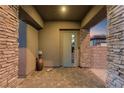 Charming front porch with stone pillars and brick pavers, creating a welcoming entrance to the home at 8 Reflection Cove Dr, Henderson, NV 89011