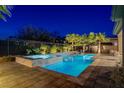Inviting backyard pool and spa with lush landscaping, perfect for evening relaxation under the stars at 8 Reflection Cove Dr, Henderson, NV 89011