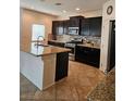 Modern kitchen with granite countertops, stainless steel appliances and a tiled backsplash at 8088 Smoking Jacket Pl, Las Vegas, NV 89166