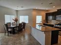 Spacious kitchen with dining area, granite countertops, stainless steel appliances and tiled floors at 8088 Smoking Jacket Pl, Las Vegas, NV 89166