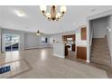 Open-concept living area with tile flooring and seamless flow into the kitchen and staircase at 8658 Tom Noon Ave # 103, Las Vegas, NV 89178