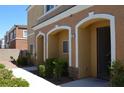 Charming front entrances to residential townhomes, and landscaped bushes at 9303 Gilcrease Ave # 1097, Las Vegas, NV 89149