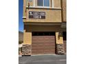 Garage door of property with stone accents beneath address sign 1097-1099 and 1098 at 9303 Gilcrease Ave # 1097, Las Vegas, NV 89149