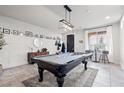 Stylish game room with a pool table, modern lighting, and elegant decor for entertainment at 9768 Fox Estate St, Las Vegas, NV 89141