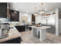 Modern kitchen features stainless steel appliances, granite countertops, and an island at 9768 Fox Estate St, Las Vegas, NV 89141