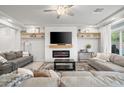 Inviting living room with a fireplace, comfortable seating, and abundant natural light at 9768 Fox Estate St, Las Vegas, NV 89141