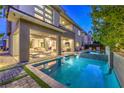 Backyard with a modern pool and spa, a covered patio, and well-maintained landscaping, perfect for outdoor living at 10 Sugarberry Ln, Las Vegas, NV 89135