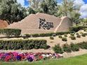 Stone community sign for The Ridges, enhanced by colorful flowers and lush greenery, creating a welcoming atmosphere at 10 Sugarberry Ln, Las Vegas, NV 89135