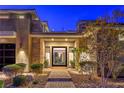 Inviting front entrance with a stone facade and manicured landscaping, adding curb appeal to the property at 10 Sugarberry Ln, Las Vegas, NV 89135