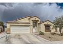 Charming single-story home featuring a two-car garage, neutral stucco, and low maintenance desert landscaping at 1010 Christopher View Ave, North Las Vegas, NV 89032