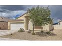Charming single-story home featuring a two-car garage, neutral stucco, and low maintenance desert landscaping at 1010 Christopher View Ave, North Las Vegas, NV 89032