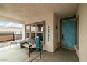 Welcoming covered entryway with seating and a colorful front door at 1131 S Blagg Rd, Pahrump, NV 89048