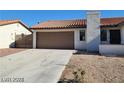 Charming single-story home features a two-car garage, low-maintenance landscaping, and a red tile roof at 1617 Joshua Tree Ct, Las Vegas, NV 89108