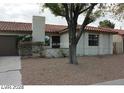 Charming single-story home features a two-car garage, low-maintenance landscaping, and a red tile roof at 1617 Joshua Tree Ct, Las Vegas, NV 89108