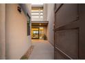 Modern home's gated entryway with desert landscaping and a view to the front door at 18 Garden Rain Dr, Las Vegas, NV 89135