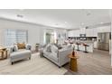 Open-concept living area with modern furnishings, flowing seamlessly into a stylish kitchen at 207 Callen Falls Ave # 1713, Henderson, NV 89011