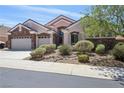 Beautiful single-story house with a three-car garage and well-maintained front yard at 2197 Big Bar Dr, Henderson, NV 89052