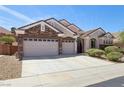 Stunning home with a three-car garage, lush landscaping, and inviting curb appeal at 2197 Big Bar Dr, Henderson, NV 89052