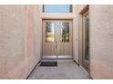 Inviting front entrance with glass-paneled doors and sidelight window at 2197 Big Bar Dr, Henderson, NV 89052