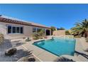 Stunning pool area with clear blue water, surrounded by desert landscaping, and a view of the home's exterior at 2470 Lothian St, Henderson, NV 89044