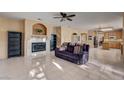 Spacious living room showcasing a fireplace, tile flooring, and seamlessly connects to the kitchen at 2636 Ontario Dr, Las Vegas, NV 89128