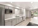 Well-lit kitchen with stainless steel appliances, light gray cabinetry, and quartz countertops at 2935 Pinehurst Dr, Las Vegas, NV 89109