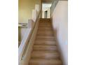 Beautiful staircase with light wood steps and neutral-colored walls leading to upper floor at 4454 Bertram Ln, Las Vegas, NV 89147