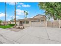 Attractive home with a two-car garage, desert landscaping, and a freshly paved driveway at 5239 Somerset Dr, Las Vegas, NV 89120