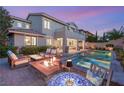 Relaxing backyard with a fire pit, spa, and outdoor seating ideal for enjoying evenings under the sky at 541 Green Sage Way, Las Vegas, NV 89138