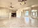 Bright, open living space boasts decorative lighting, tile flooring, and an open layout to the kitchen at 5451 Fernwood Ct, Pahrump, NV 89061