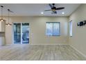 Bright living room featuring wood-look tile floors, recessed lighting, and sliding glass door to patio at 5697 Garriga Dr, Las Vegas, NV 89135