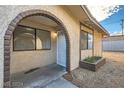 Home exterior showcasing an arched brick entrance, tidy landscaping, and a secure front door at 5913 Smoke Ranch Rd # A, Las Vegas, NV 89108