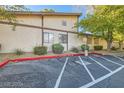 View of a multi-unit dwelling featuring parking and neat landscaping around the building at 5913 Smoke Ranch Rd # A, Las Vegas, NV 89108