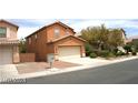 Two-story home featuring an attached two-car garage and low maintenance landscaping at 6528 Chebec St, North Las Vegas, NV 89084