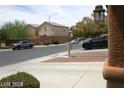 View of a residential street with cars parked and a home's exterior visible in the background at 6528 Chebec St, North Las Vegas, NV 89084