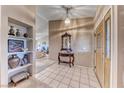 Inviting foyer with neutral tones, tile flooring, decorative shelving, and elegant accents creating a warm welcome at 7533 Grenfell Dr, Las Vegas, NV 89129