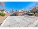 Long driveway leading to a well-kept home with drought resistant landscaping on a sunny day at 8348 Mountain Destiny Ave, Las Vegas, NV 89131